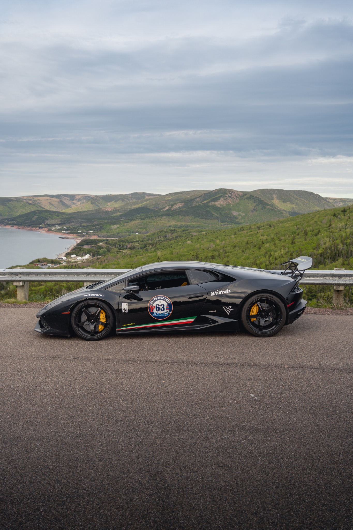 The Huracán in its original black finish on a scenic drive.