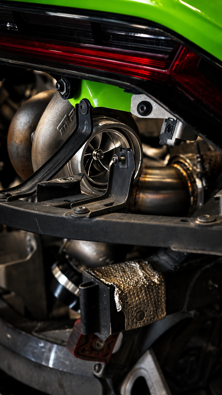 Turbo and exhaust fabrication detail beneath the rear light.