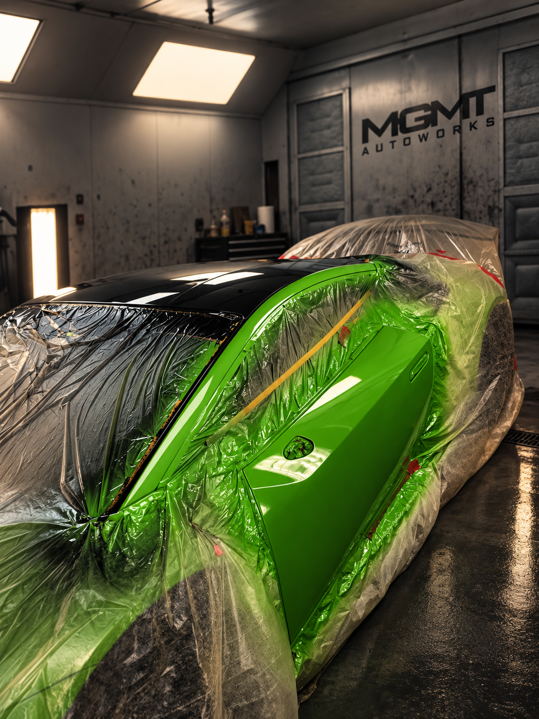 Painted bodywork masked during finishing work at MGMT Autoworks.